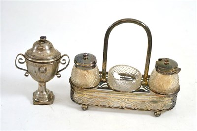 Lot 614 - A silver mounted glass three piece condiment set and stand, and a silver plated urn