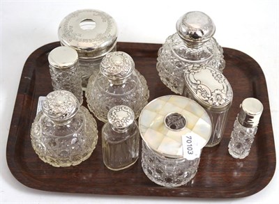 Lot 634 - Nine late Victorian/Edwardian silver topped and cut glass scent bottles