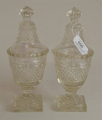 Lot 696 - A pair of cut glass urns and covers