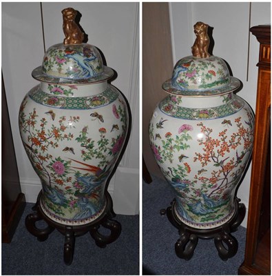 Lot 707 - A pair of Chinese porcelain baluster jars and covers, in 18th century style, painted in famille...