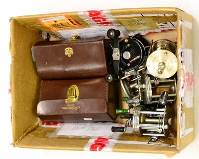 Lot 1033 - A Cased Abu Ambassadeur No.6000 Multiplying Reel, together with an empty leather case and six other