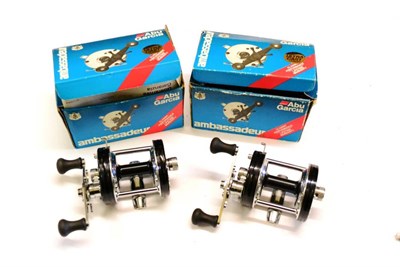 Lot 1105 - Two Boxed Abu Ambassadeur 6500 CT Casting Reels, both with metallic black finish, instructions...