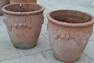 Lot 1327 - Pair of large terracotta planters decorated with vines and fruit, 65cm diameter