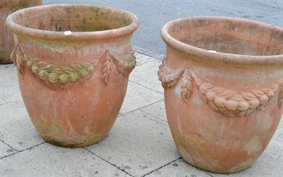 Lot 1334 - Pair of large terracotta planters decorated with swags, 69cm diameter