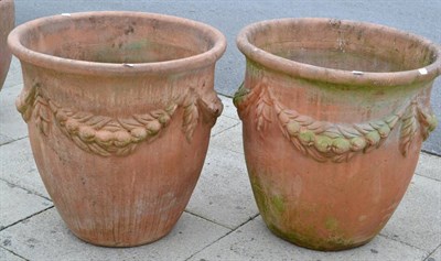 Lot 1335 - Pair of large terracotta planters decorated with swags, 69cm diameter