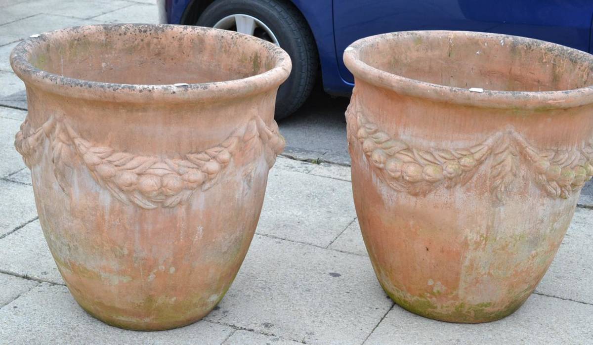 Lot 1336 - Pair of large terracotta planters decorated with swags, 69cm diameter