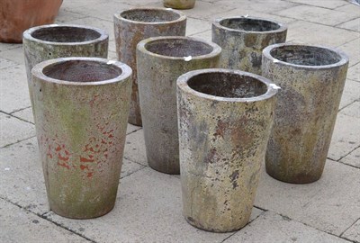 Lot 1350 - Set of seven terracotta cylindrical planters, 52cm high