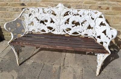 Lot 1362 - A Coalbrookdale style cast iron fern bench, white painted with wooden slat seat, on foliate...