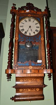 Lot 1402 - An inlaid striking wall clock, circa 1890, turned side columns, elaborately decorated with...