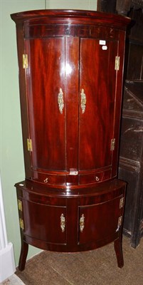 Lot 1404 - George III mahogany bow fronted corner cupboard on associated base