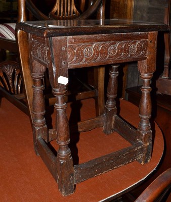 Lot 1410 - A 17th century oak joint stool with carved frieze