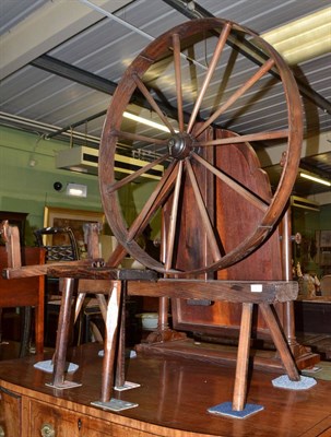 Lot 1423 - An early 19th century spinning wheel on square chamfered legs and an early 19th century oak...