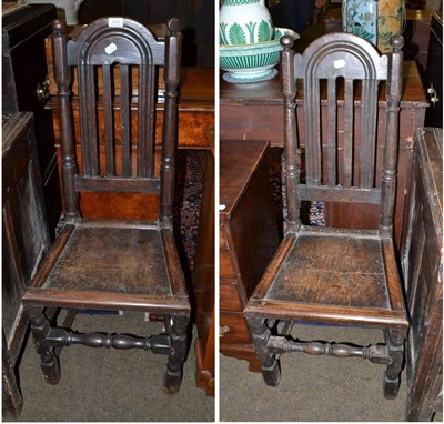 Lot 1434 - A pair of early 18th century joined oak chairs with solid seats