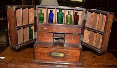 Lot 1447 - A 19th century travelling apothecary cabinet with key