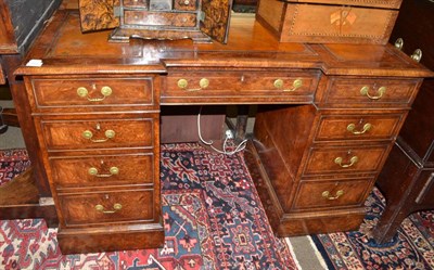 Lot 1450 - A reproduction walnut inverted breakfront double pedestal desk