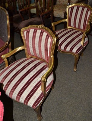 Lot 1460 - A pair of gilt framed striped armchairs