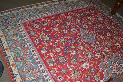 Lot 1482 - Nejafad Isfahan carpet, central Persia, the crimson field of scrolling vines around a sky blue...