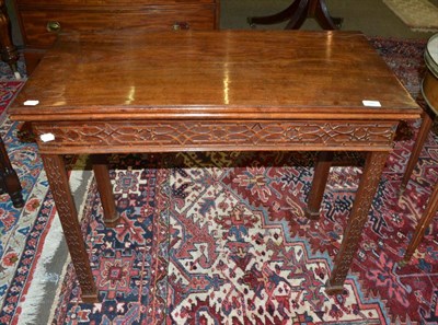 Lot 1485 - A 19th century mahogany card table with blind fret carved detailing