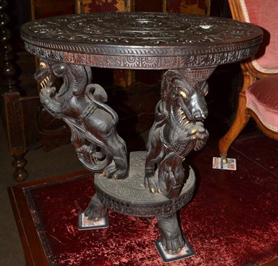 Lot 1502 - A carved Indian ebonised circular table