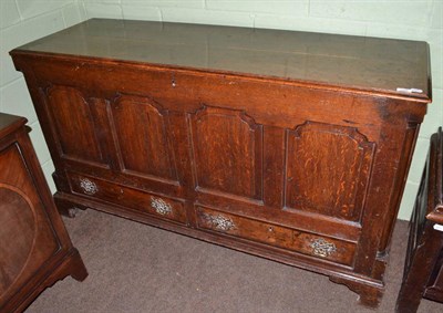 Lot 1529 - A George III joined oak chest with hinged lid and field panels