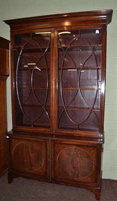 Lot 1531 - A 19th century glazed door bookcase, the base with two satinwood banded cupboard doors