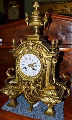 Lot 1540 - A gilt metal striking mantel clock, circa 1890, case with scroll mounts and acorn finials,...