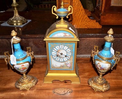 Lot 1547 - A gilt metal and porcelain mounted striking mantel clock with garniture, circa 1890, porcelain...