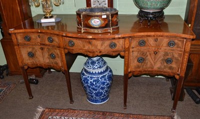 Lot 1556 - A George III mahogany, satinwood banded and marquetry decorated serpentine fronted sideboard, circa