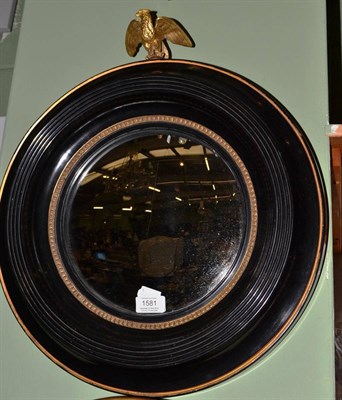 Lot 1581 - A convex mirror, mounted with an eagle