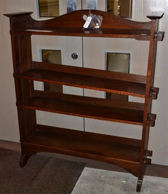 Lot 1584 - An Arts & Crafts oak open bookcase, the raised up-stand with pierced heart motif, above four...