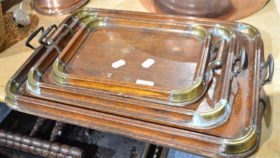 Lot 1602 - A green onyx clock and a set of three oak and brass bound graduated trays