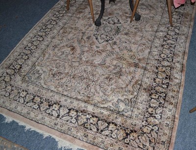 Lot 1624 - Machine made carpet of Oriental design, the indigo field with an allover design of palmettes...