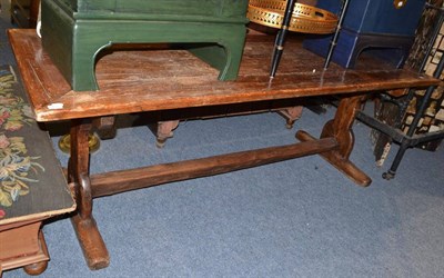 Lot 1635 - A pine plank top trestle dining table, 216cm long