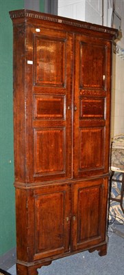 Lot 1657 - A George III oak and mahogany crossbanded free-standing corner cupboard, late 18th century, the...