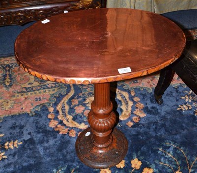 Lot 1663 - Fluted pedestal cast iron table with oval copper top