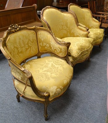 Lot 1704 - A pair of late 19th century French style gilt framed armchairs upholstered in yellow watered...