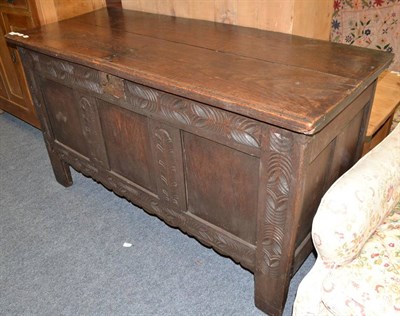 Lot 1729 - An 18th century oak coffer with carved panels