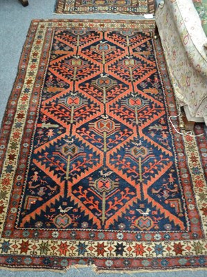 Lot 1731 - Early 20th century Feraghan rug, West Persia, the indigo serrated diamond lattice field with tribal