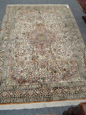 Lot 1758 - Kashmir silk piled rug, North West India, the ivory field of scrolling floral vines centred by...