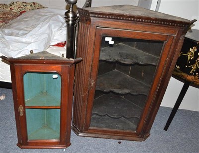 Lot 1777 - George III oak hanging corner cupboard with fluted stiles and a small mahogany hanging corner...