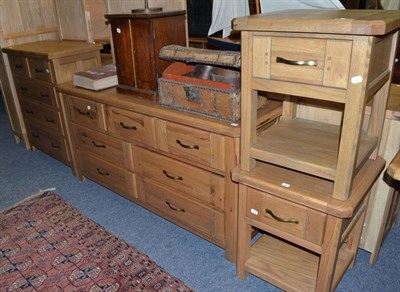 Lot 1779 - A pair of reproduction oak bedside cabinets, matching five drawer chest and a matching seven drawer