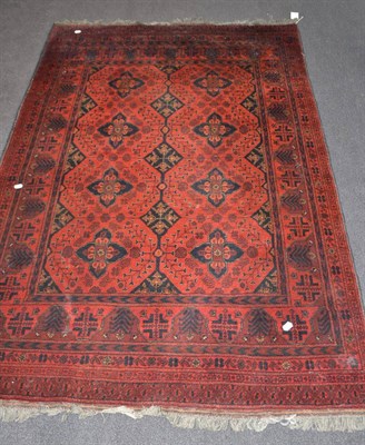 Lot 1791 - An Afghan rug, North West Afghanistan, the brick red field with two columns of cruciform guls...