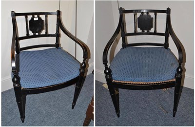 Lot 1836 - Set of four Regency ebonised open armchairs with caned seats and squabs