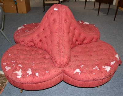 Lot 1841 - A Victorian conversation seat, of quatrefoil form, covered in deep-buttoned crimson damask, on...