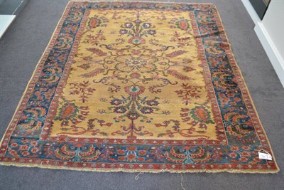 Lot 1857 - Kurdish rug, Persian Kurdistan, the pale camel field of scrolling vines enclosed by indigo...