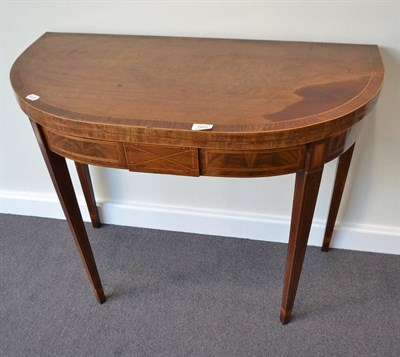 Lot 1858 - A Georgian inlaid mahogany games table