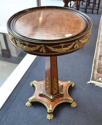 Lot 1863 - A French style drum top pedestal table with gilt metal mounts and paw feet