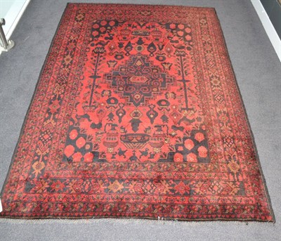 Lot 1869 - An Afghan rug, North West Afghanistan, the claret field with central stepped medallion framed...