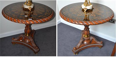 Lot 1870 - A pair of glass topped pedestal tables, with triform bases and acanthus carved supports