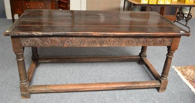 Lot 1876 - A 17th style oak refectory table, of four plank construction with cleated ends above a lunette...